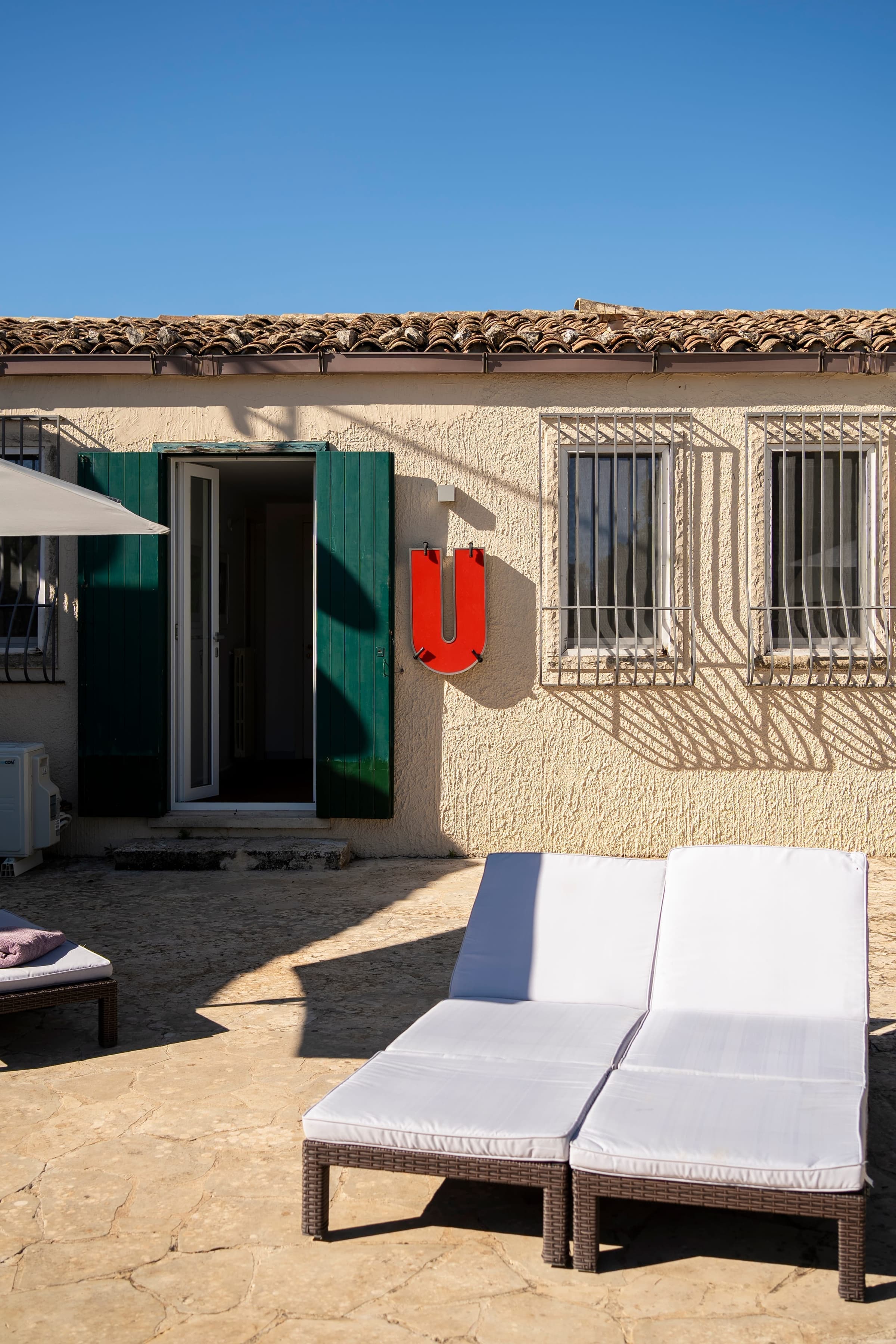 Pool terrace with sun loungers and garden surroundings