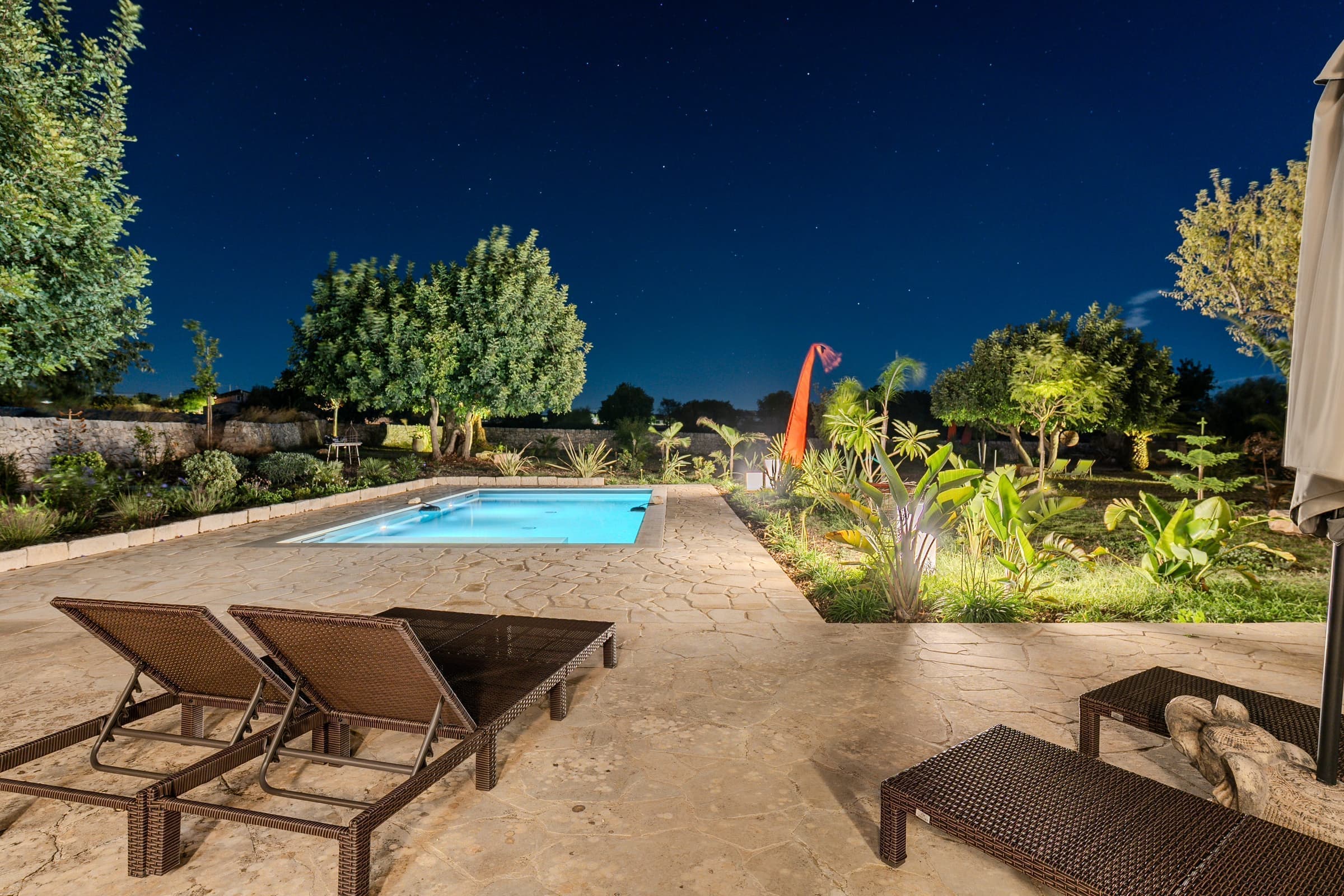 Pool surrounded by tropical plants and evening ambiance