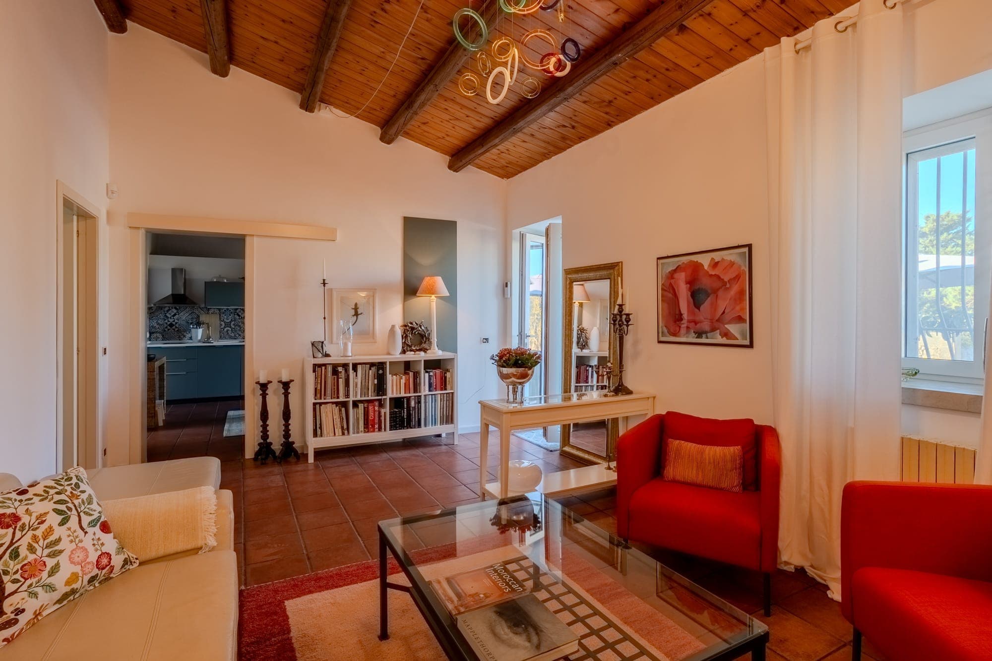 Spacious living area with colorful chandelier